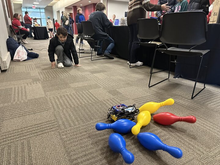 Bowling pins being knocked down by a robot